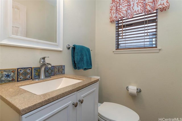 half bathroom featuring toilet and vanity