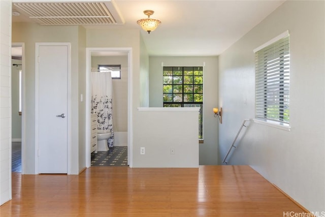 foyer with visible vents and wood finished floors