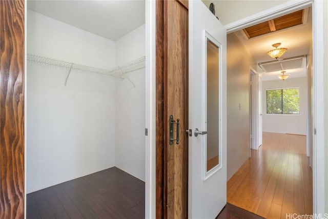 hall with attic access and dark wood finished floors