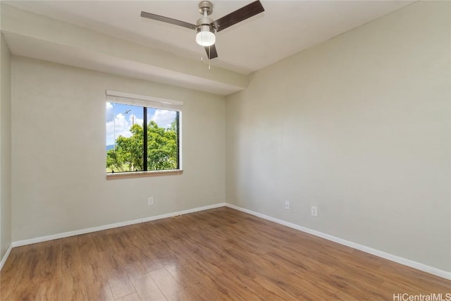 unfurnished room with ceiling fan, wood finished floors, and baseboards