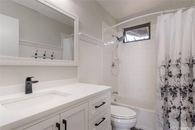 full bath with shower / bath combo, vanity, and toilet