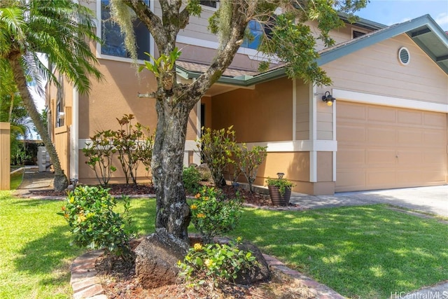 view of front of house featuring a garage, a front yard, and stucco siding