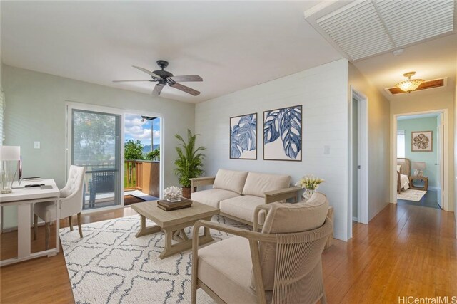 living room with ceiling fan and light wood-type flooring