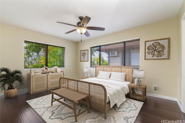 bedroom featuring dark wood-type flooring, ceiling fan, and baseboards