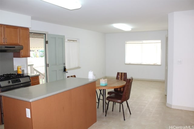 kitchen featuring black gas stove and a healthy amount of sunlight