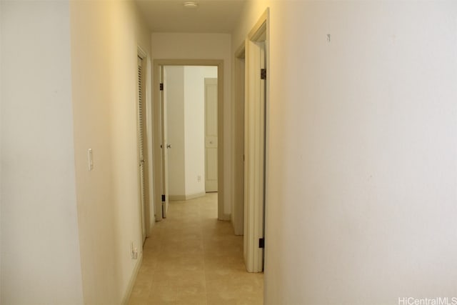 corridor with light tile patterned flooring