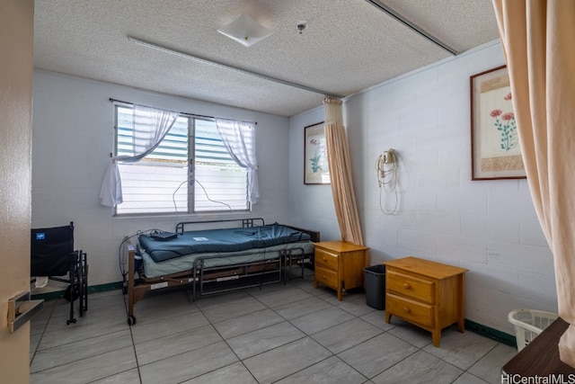 bedroom featuring a textured ceiling and light tile patterned flooring