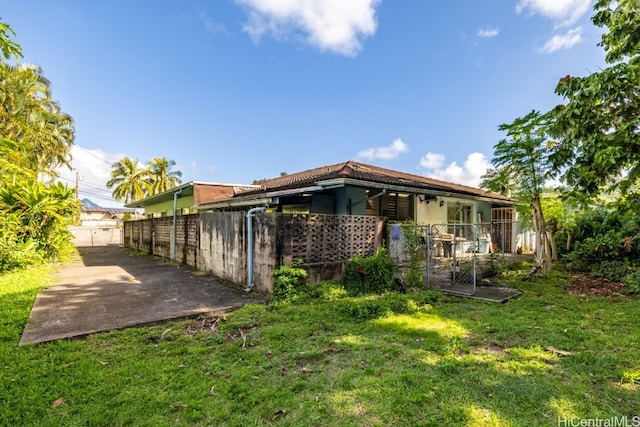 back of house with a lawn