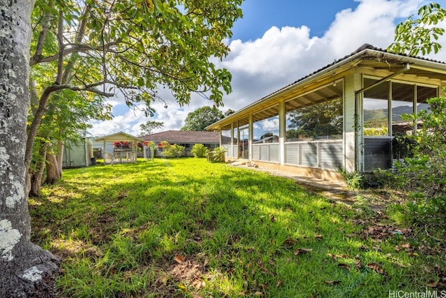 view of yard with a sunroom