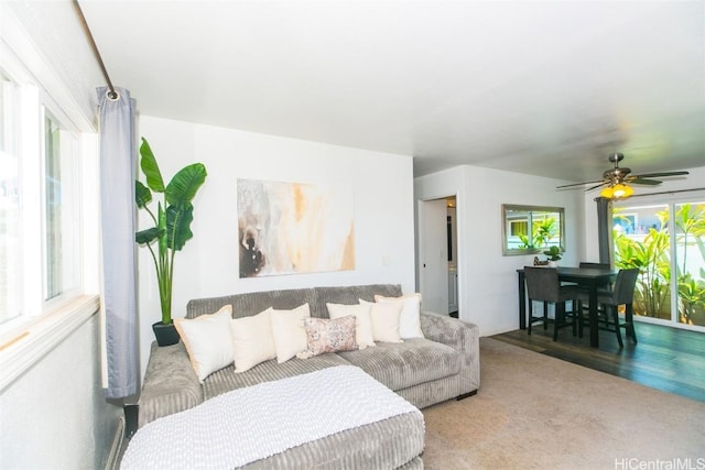 living room featuring ceiling fan and carpet