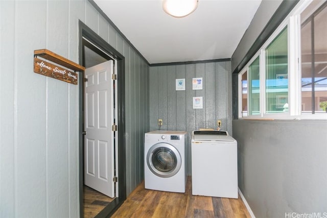 laundry area featuring dark hardwood / wood-style floors and separate washer and dryer