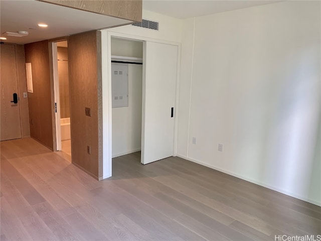 unfurnished bedroom with a closet and wood-type flooring