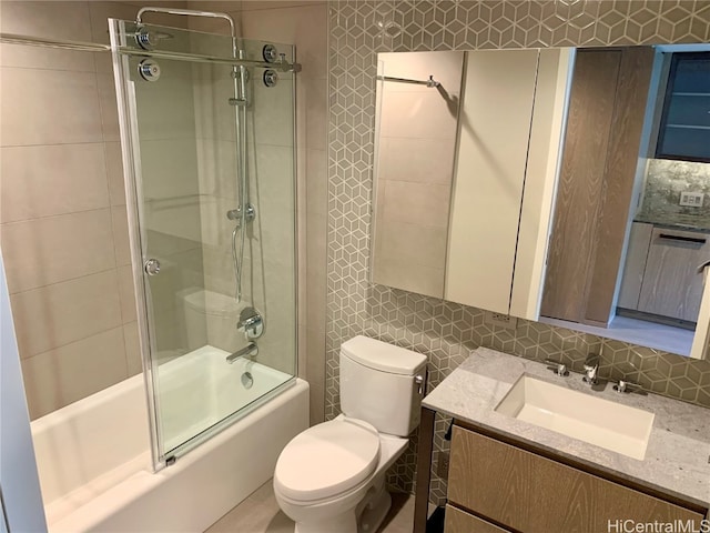 full bathroom with enclosed tub / shower combo, tasteful backsplash, toilet, and vanity