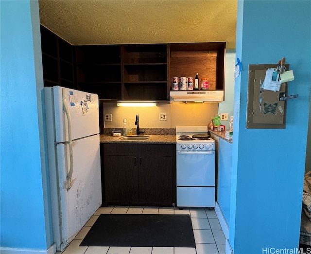 kitchen with white appliances, light tile patterned floors, a textured ceiling, and sink