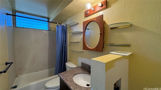 full bathroom featuring toilet, a textured ceiling, shower / bath combo with shower curtain, and vanity