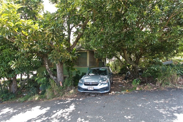 view of property hidden behind natural elements