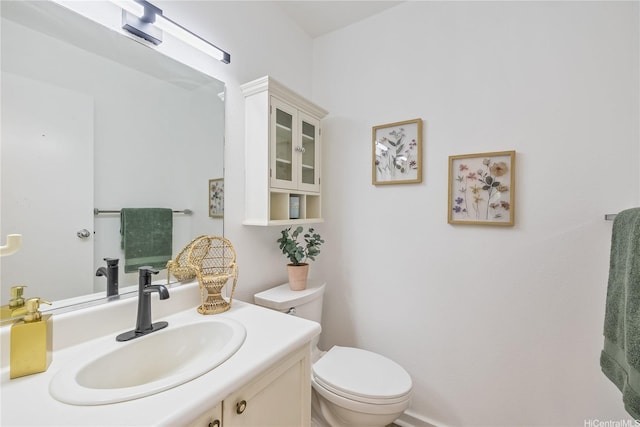 bathroom with toilet and vanity