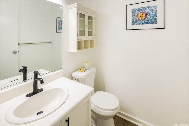 91-1019 Hiluhilu St, Kapolei, HI 96707 - half bathroom with toilet, vanity, baseboards, and wood finished floors