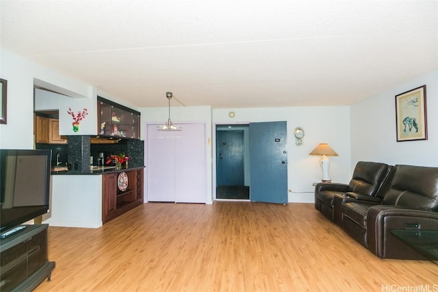 living room with light wood-type flooring and bar