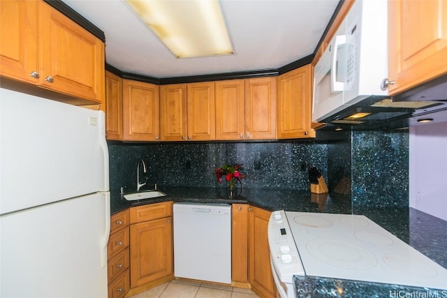 kitchen with sink, white appliances, dark stone countertops, and tasteful backsplash