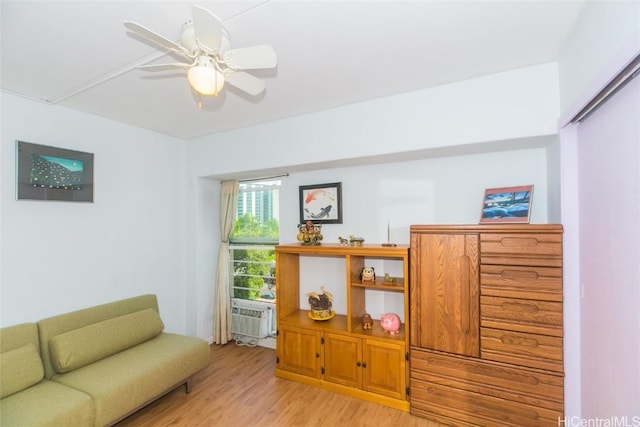 sitting room with ceiling fan and light hardwood / wood-style flooring