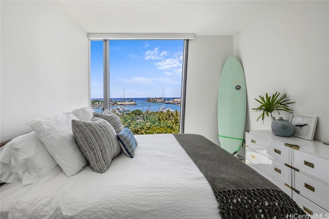 bedroom with a water view and floor to ceiling windows