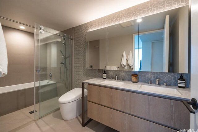 bathroom featuring vanity, a shower with shower door, toilet, and tasteful backsplash