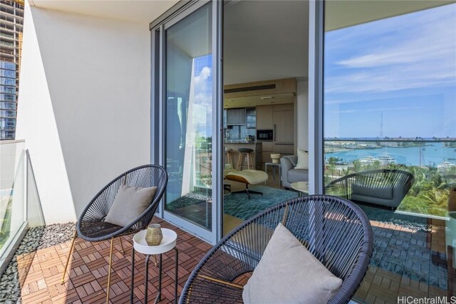 balcony featuring a water view