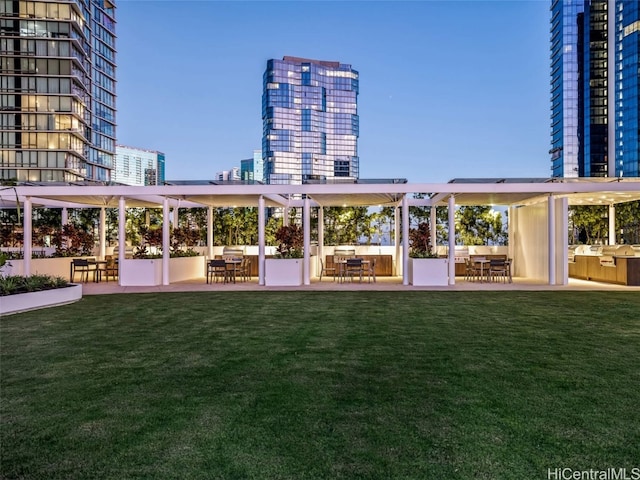 rear view of house with an outdoor bar, a yard, a patio, and a pergola