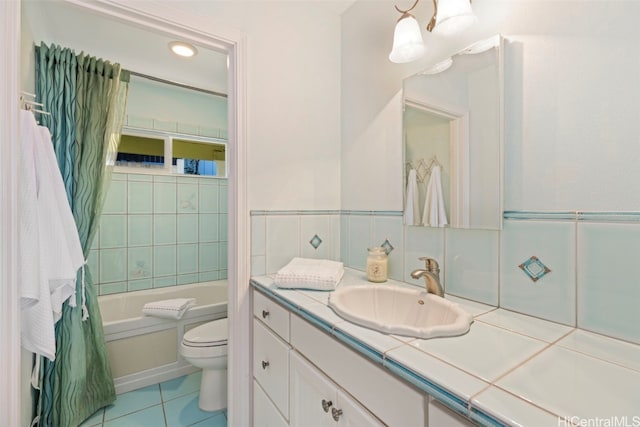 bathroom featuring tile patterned floors, vanity, a bath, and toilet