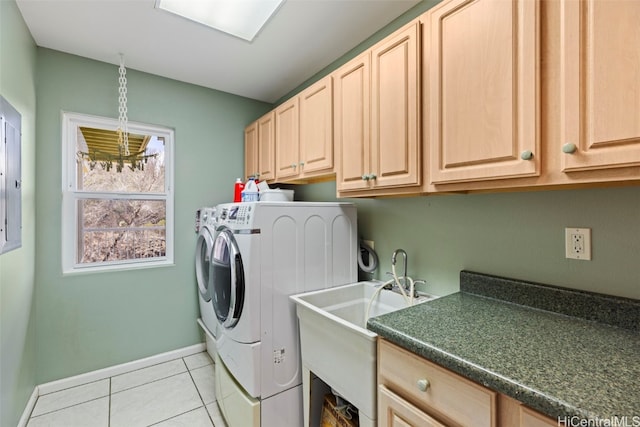 washroom featuring washing machine and clothes dryer, light tile patterned floors, and cabinets