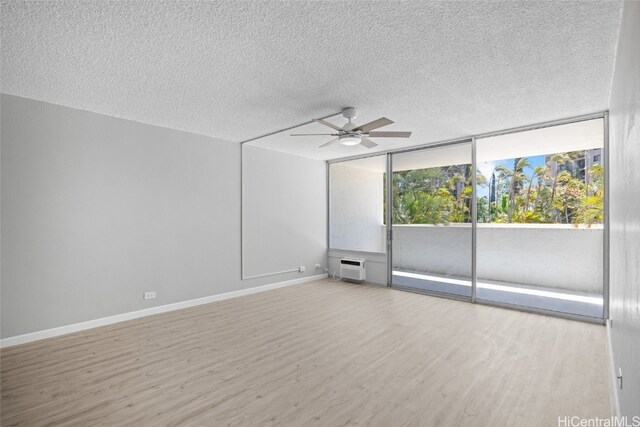 unfurnished room featuring a textured ceiling, light wood-type flooring, and ceiling fan