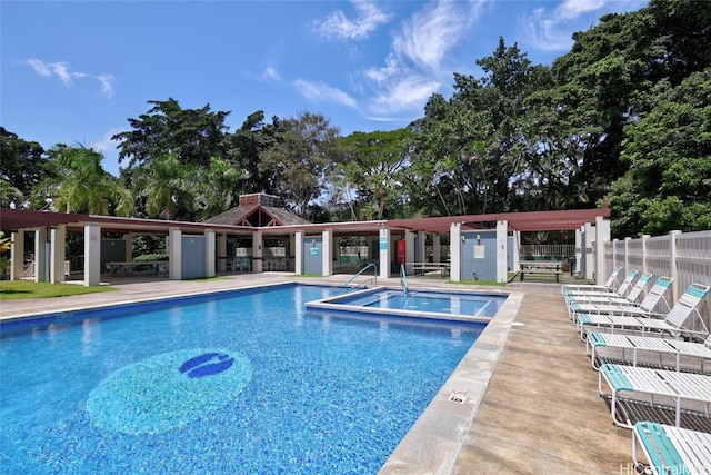 view of swimming pool with a patio area and an outbuilding