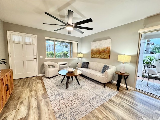 living room with light wood-type flooring and ceiling fan