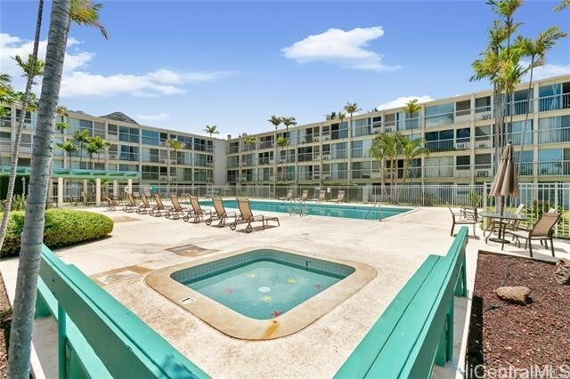 view of pool with a community hot tub and a patio