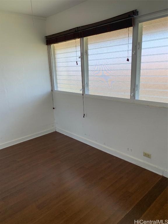 empty room with dark wood-type flooring