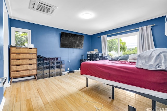 bedroom with hardwood / wood-style flooring