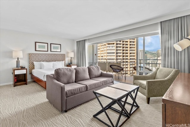 bedroom featuring light carpet and access to exterior