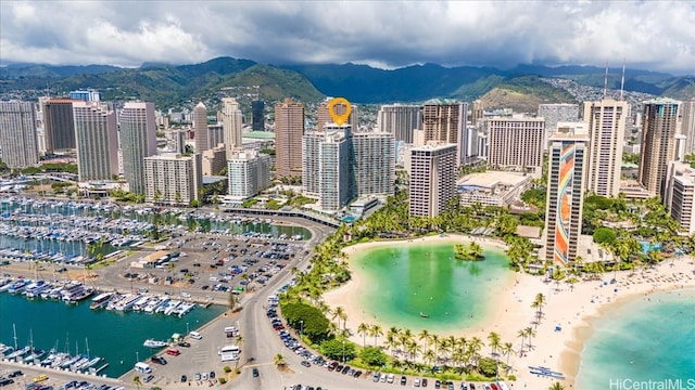 bird's eye view featuring a water and mountain view and a beach view