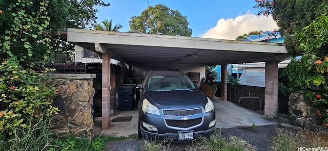 parking at dusk featuring a carport