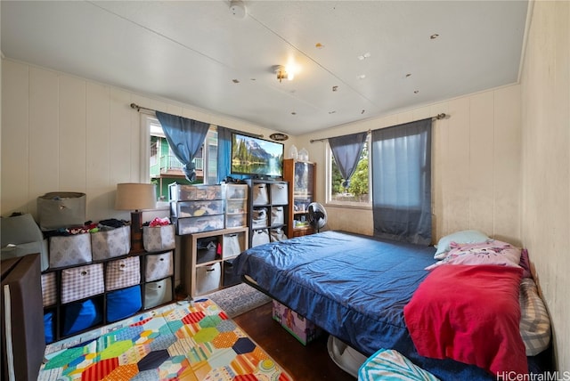 bedroom with hardwood / wood-style flooring and multiple windows