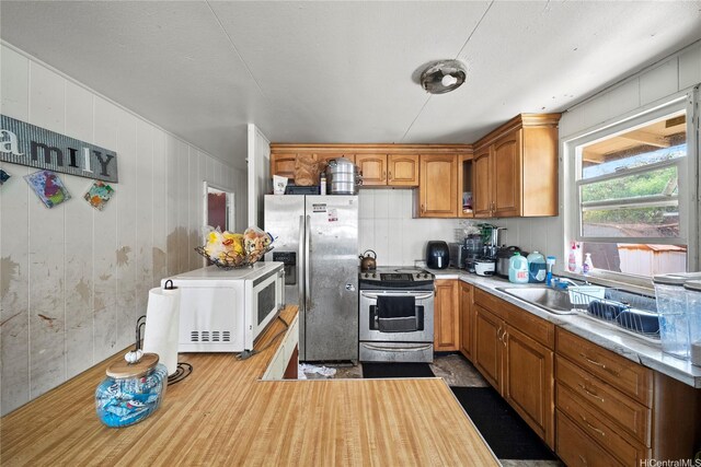 91-669 Pohakupuna Rd, Ewa Beach, HI 96706 - kitchen with a sink, brown cabinets, appliances with stainless steel finishes, and light countertops
