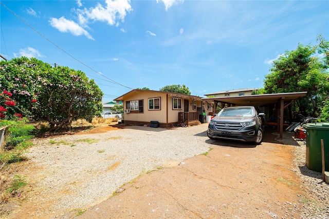 91-669 Pohakupuna Rd, Ewa Beach, HI 96706 - manufactured / mobile home with a carport and dirt driveway