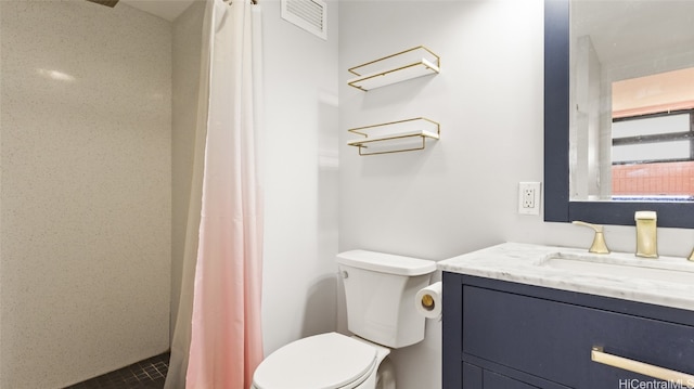 bathroom featuring vanity, toilet, and curtained shower