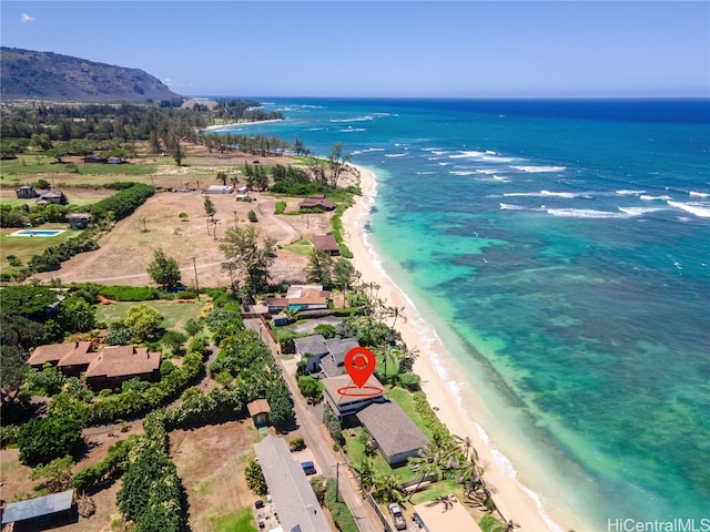 aerial view with a water view and a beach view