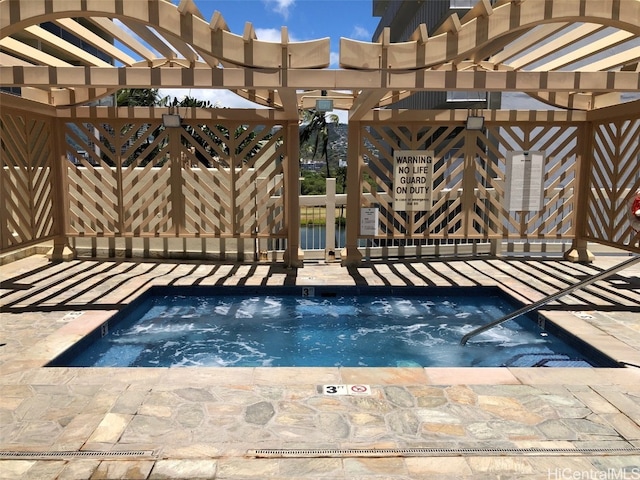 view of swimming pool featuring an in ground hot tub and a pergola