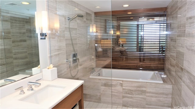 bathroom featuring vanity and separate shower and tub