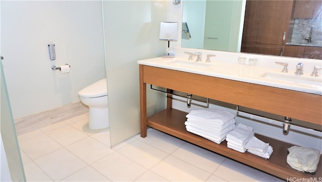 bathroom featuring toilet, vanity, and tile patterned floors