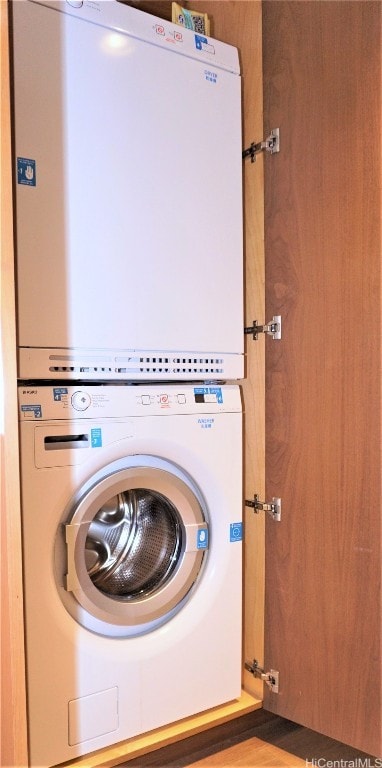 laundry area with stacked washer and dryer