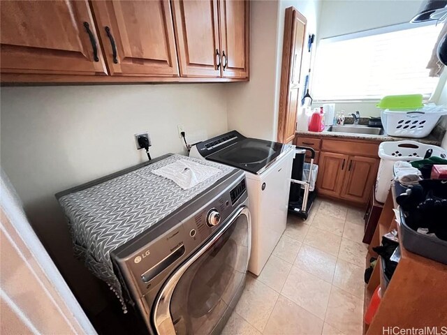 laundry room featuring sink, cabinets, and separate washer and dryer